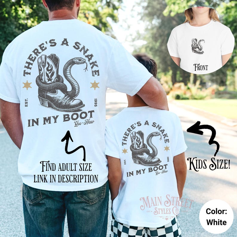 May include: White t-shirt with a graphic of a snake in a cowboy boot and the text "There's a Snake in My Boot Yee-Haw". The shirt is available in adult and kids sizes.
