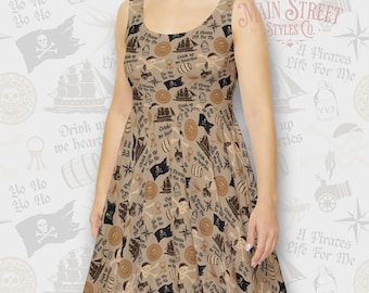 May include: A beige sleeveless dress with a pirate-themed print. The print features a variety of images, including ships, skulls, crossbones, and the text "A Pirates Life For Me".
