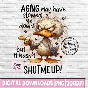 May include: A digital graphic design featuring a grumpy, dishevelled duck with an orange beak and feet, pointing its wing. The text reads: AGING May have slowed me down but it hasn't SHUT ME UP! Includes a Sassy By Sue heart and Original Designer stamp.