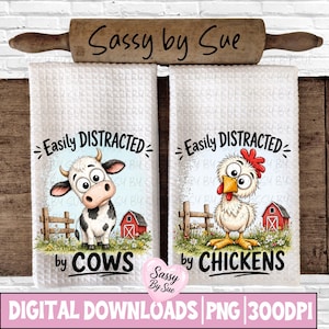 May include: Two white waffle-weave kitchen towels with the text "Easily DISTRACTED" above cartoon images of a cow and a chicken. The cow towel says "by COWS" and the chicken towel says "by CHICKENS". A wooden rolling pin is above the towels.