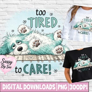 May include: A digital graphic design featuring a fluffy, teal and white dog lying on its back on a rug with the text "too TIRED to CARE!". The design is shown printed on a white long-sleeve shirt and a black t-shirt, with a pink heart logo.