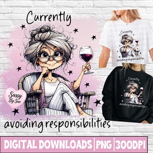 May include: A graphic design featuring a cartoon character with gray hair and glasses sitting in a chair, holding a glass of red wine. The text reads Currently avoiding responsibilities. The design is shown on a white t-shirt and a black sweatshirt.