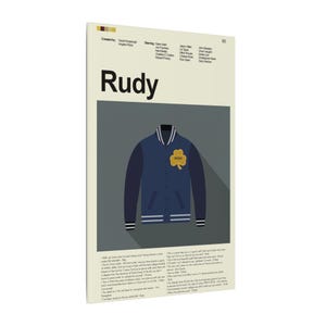 May include: A poster featuring the movie title "Rudy" in bold black letters. Below the title is a navy blue varsity jacket with a gold shamrock patch. The poster has a cream-colored background with text at the top and bottom.