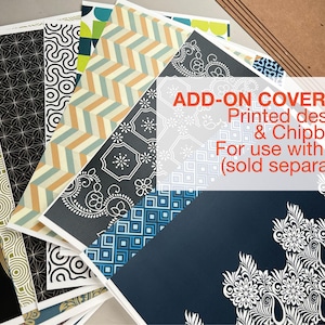May include: A collection of patterned paper sheets with various designs, including geometric, floral, and abstract patterns. The text "ADD-ON COVER-KIT Printed designs & Chipboard For use with Jigs (sold separately)" is visible. The papers are in shades of blue, beige, black, and white.