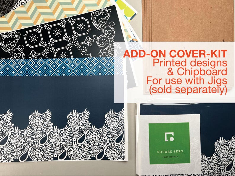 May include: Assortment of patterned paper sheets with floral, geometric, and paisley designs in navy, black, white, and blue. The text "ADD-ON COVER-KIT" and "Printed designs & Chipboard" is visible. A Square Zero cover design kit is also included.