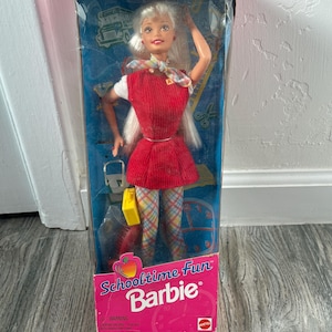 May include: A white ceramic mug with a black handle and the text "But First, Coffee" in a bold, black font. The mug is set against a neutral background, highlighting its simple design.