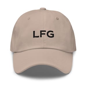 May include: A beige dad hat with black embroidered text that reads "LF G"