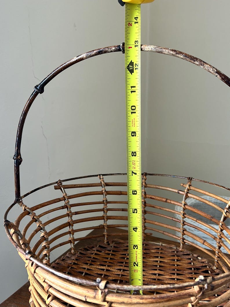 May include: A brown wicker basket with a metal handle. The basket is 12 inches tall.