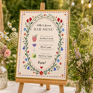 Whimsical floral wedding bar menu sign with colorful folk art border and illustrated drinks, editable Canva template displayed on easel and table settings