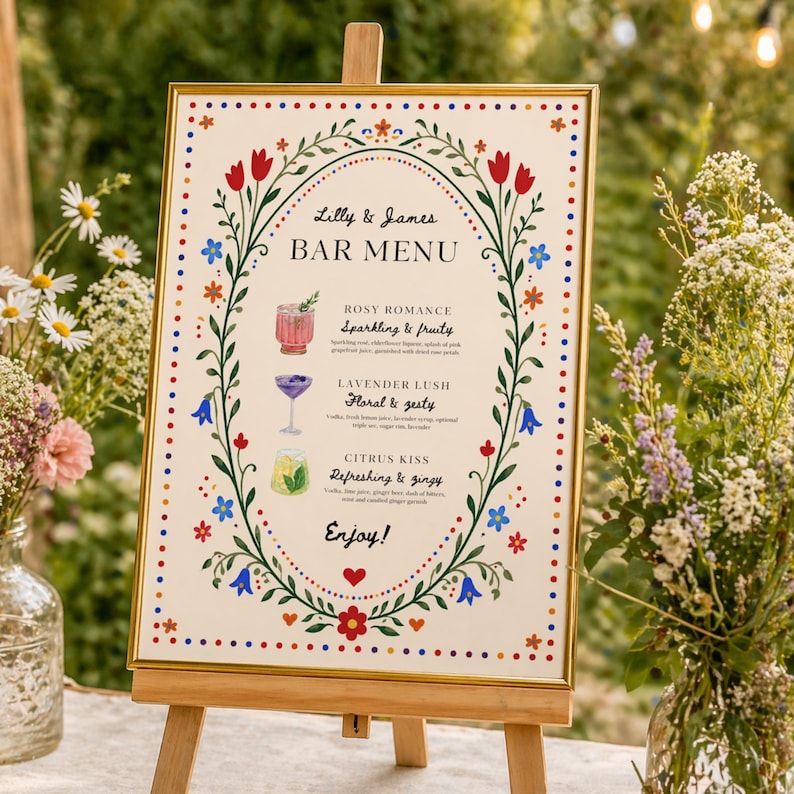 Whimsical floral wedding bar menu sign with colorful folk art border and illustrated drinks, editable Canva template displayed on easel and table settings