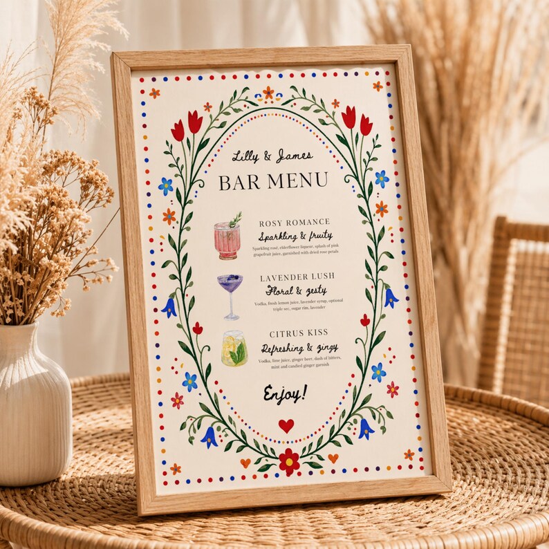 Whimsical floral wedding bar menu sign with colorful folk art border and illustrated drinks, editable Canva template displayed on easel and table settings
