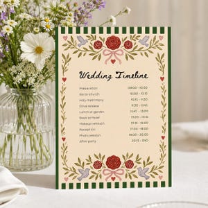 May include: A rectangular wedding timeline card with a cream background and dark green striped borders. The card features red rose illustrations, pink bows, and small birds. Text includes 'Wedding Timeline' and a schedule from 08:00 to 20:15.