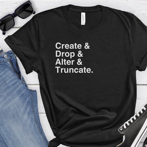 May include: Black t-shirt with white text that reads "Create & Drop & Alter & Truncate."