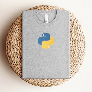 May include: A gray t-shirt with a yellow and blue Python logo on the front.