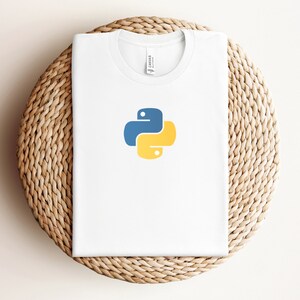 May include: White t-shirt with a blue and yellow Python logo.