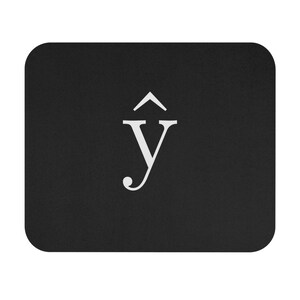 May include: A black rectangular mousepad with a white stylized letter "Y" featuring a circumflex accent. The mousepad has rounded corners and a textured surface, providing a smooth area for mouse movement.