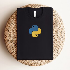 May include: Black t-shirt with a yellow and blue Python logo.