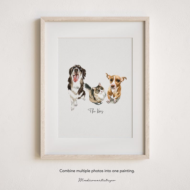 May include: Watercolour painting of three pets: a dog, a cat, and another dog. The dog on the left is black and white with its tongue out. The cat is grey and brown. The dog on the right is brown and white. The painting is in a white frame.