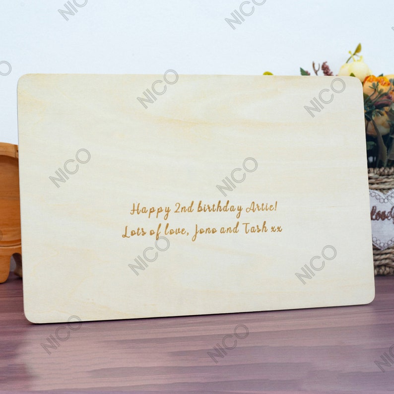 May include: A wooden plaque with a personalized message: "Happy 2nd birthday Artie! Lots of love, Jono and Tash xx".