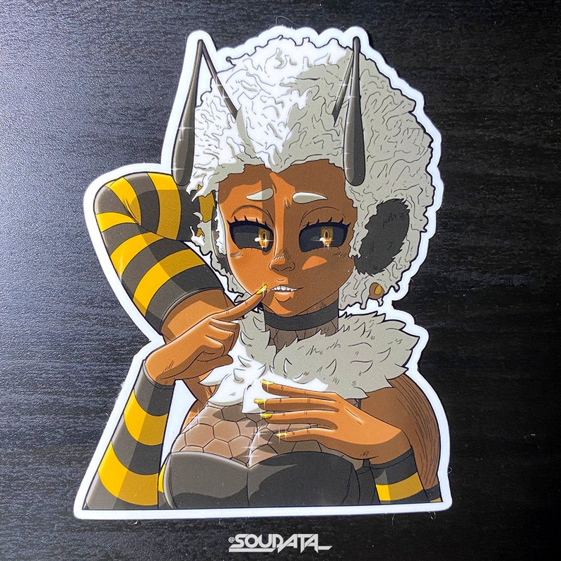 May include: A sticker featuring a cartoon character with a bee-themed outfit. The character has yellow and black striped sleeves, a fluffy white hairdo, and a black and gold outfit. The character is smiling and has large, expressive eyes.