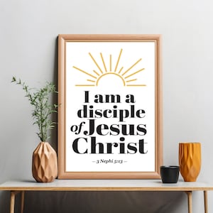 May include: A framed print with a gold sun graphic and the text "I am a disciple of Jesus Christ - 3 Nephi 5:13 -" in black bold font.