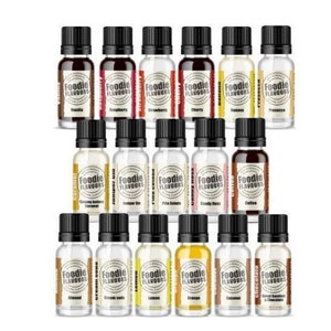 May include: A collection of 18 small glass bottles with labels that say "Foodie Flavours" and various flavour names. The bottles are arranged in three rows of six bottles each.