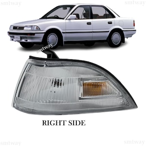 May include: A clear white and amber car indicator light for the right side of a vehicle. The light has a black housing and a clear lens. The light is designed to be used on a car.
