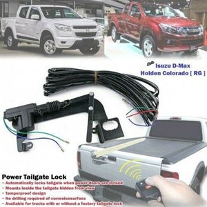 May include: A power tailgate lock kit for trucks. The kit includes a black electric actuator, wiring harness, and a remote control. The kit is compatible with Isuzu D-Max and Holden Colorado [RG] trucks. The text on the image reads: "Power Tailgate Lock - Automatically locks tailgate when power doors are locked - Mounts inside the tailgate hidden from view - Tamperproof design - No drilling required of corrosionsurface - Available for trucks with or without a factory tailgate lock"