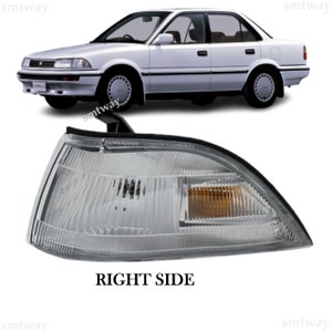 May include: A clear white and amber car indicator light for the right side of a vehicle. The light has a black housing and a clear lens. The light is designed to be used on a car.