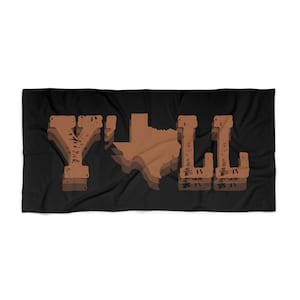 May include: A black beach towel with the text "Y'ALL" in brown letters with a brown outline of the state of Texas in the middle.