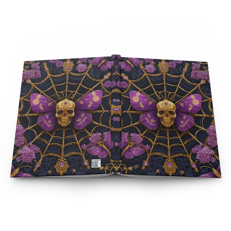 Hardcover journal featuring an ornate gothic design of a golden skull with purple butterfly wings at the center of a golden spiderweb. Surrounded by rich purple flowers, butterflies, and intricate details, all set against a dark, swirling background.
