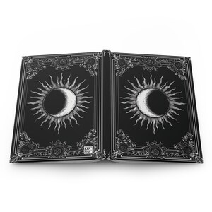 Let your thoughts drift into the mystical with this Gothic Sun & Moon Eclipse Journal. The ornate vintage border and celestial centerpiece make it the perfect notebook for witches, poets, and dark academia lovers alike.