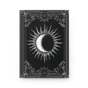 Let your thoughts drift into the mystical with this Gothic Sun & Moon Eclipse Journal. The ornate vintage border and celestial centerpiece make it the perfect notebook for witches, poets, and dark academia lovers alike.