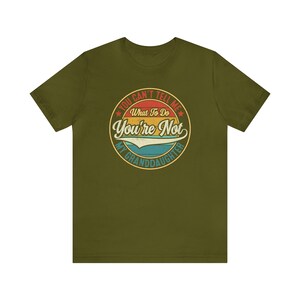 May include: Olive green t-shirt with a vintage-style circular graphic that says "You Can't Tell Me What To Do You're Not My Granddaughter".