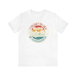 May include: White t-shirt with a vintage-style graphic that says "You can't tell me what to do, you're not my granddaughter".