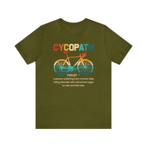May include: Green t-shirt with a retro-style graphic of a bicycle and the text "CYCOPATH noun a person suffering from chronic bike riding disorder with abnormal urges to ride and feel free."