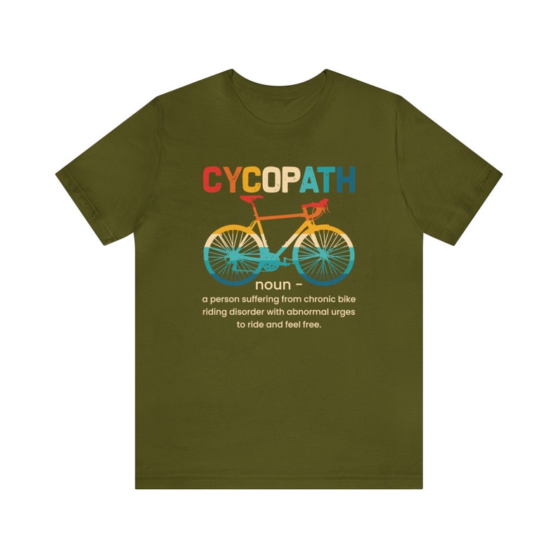 May include: Green t-shirt with a retro-style graphic of a bicycle and the text "CYCOPATH noun a person suffering from chronic bike riding disorder with abnormal urges to ride and feel free."