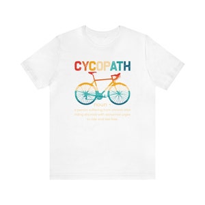 May include: White t-shirt with a vintage-style graphic of a bicycle and the text "CYCOPATH" defined as "a person suffering from chronic bike riding disorder with abnormal urges to ride and feel free."