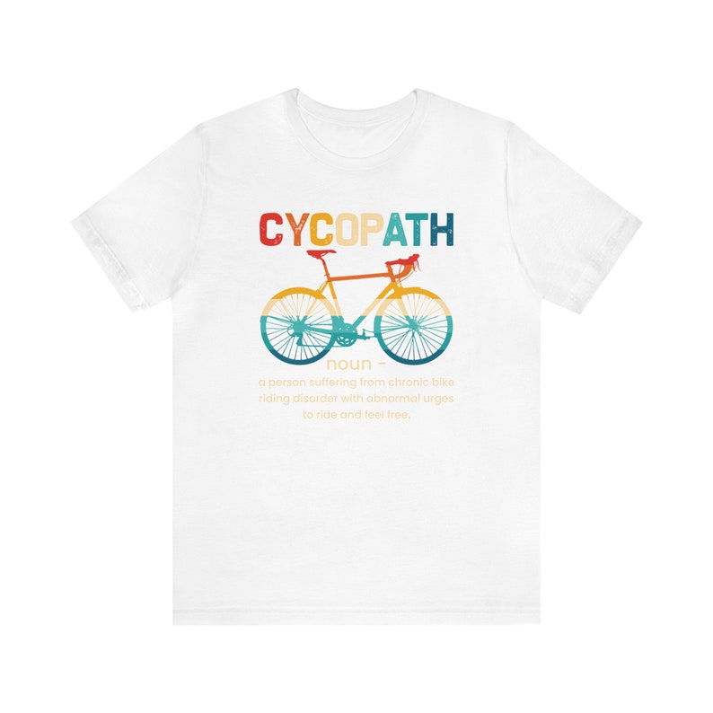 May include: White t-shirt with a vintage-style graphic of a bicycle and the text "CYCOPATH" defined as "a person suffering from chronic bike riding disorder with abnormal urges to ride and feel free."