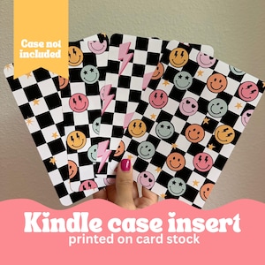 May include: Set of six colorful checkerboard patterned Kindle case inserts with smiley faces and lightning bolts. The inserts are printed on card stock.