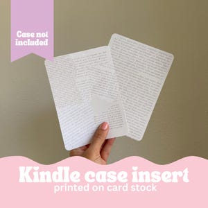 May include: Two white cardstock inserts for a Kindle case, printed with a dense, black and white text pattern. The text is in a cursive font. The text is not legible. The text is printed on both sides of the inserts. The inserts are held in a hand. The text at the bottom of the image reads "Kindle case insert printed on card stock".