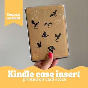 May include: A Kindle case insert printed on card stock with a design of black dragons flying on a yellow and brown background. The text "Case not included" is visible in the top left corner.