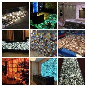 May include: A collection of agate slabs in various colors and patterns, illuminated from behind. The slabs are used as decorative wall panels and countertops.