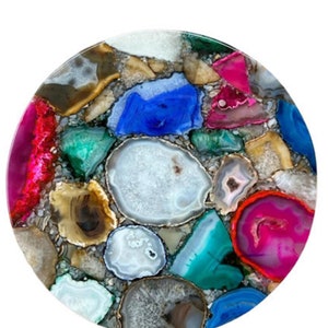 May include: A round, colourful agate table top with a variety of different shapes and sizes of agate slices. The agate slices are in shades of pink, blue, green, brown, and white.