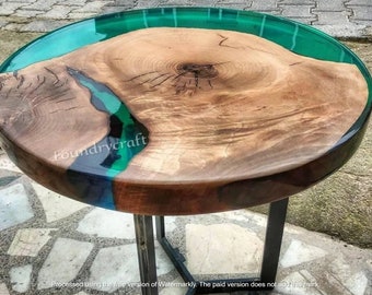 May include: Round wooden table top with a green and blue epoxy resin inlay. The table has a black metal base.