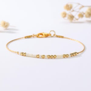 May include: A set of three ceramic mugs with a speckled, matte finish in cream, light grey, and dark grey. Each mug has a simple, minimalist design, ideal for tea or coffee.