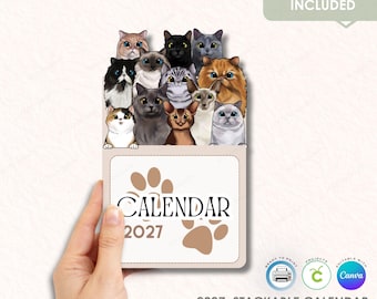May include: A stackable 2027 calendar featuring a collection of illustrated cats of various breeds and colors. The calendar has a paw print design and the word "CALENDAR" printed on the front. The text "ANNUAL UPDATE INCLUDED" is also visible.