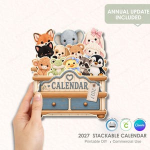 May include: A 2027 printable calendar featuring a wooden-style stand with two blue drawers and a collection of cartoon animals including a fox, elephant, rabbit, cat, dog, bear, sheep, frog, chick, raccoon, and penguin sitting on top.