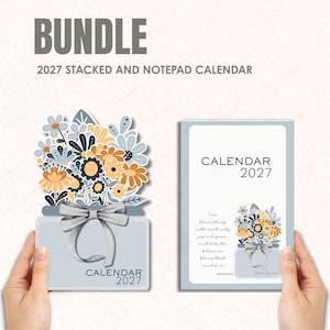 May include: A 2027 bundle featuring a stacked calendar and a notepad calendar. The stacked calendar is shaped like a jar of flowers with a grey ribbon. The notepad calendar is rectangular with the text CALENDAR 2027 and a floral illustration.