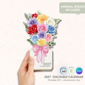 May include: A 2027 stackable calendar featuring a watercolour illustration of vibrant roses and a pink bow. The calendar, held by a hand, includes the text "Annual Update Included". It's designed for printable DIY and commercial use.